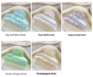 Set of five small marble texture acetate hair claws in pastel colors shown in a grid