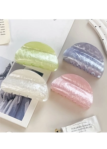 Flat lay of four marble pattern hair claws in pastel green, purple, cream, and pink colors