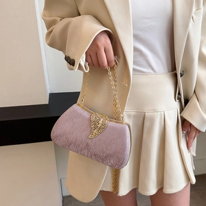 Pink shimmering box clutch bag with golden leaf clasp and chain strap for evening events