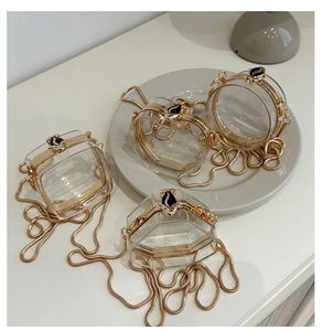 Detailed view of 4 mini acrylic chain bags in geometric shapes with gold fox clasp