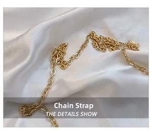 Detail showing high-quality gold chain shoulder strap on elegant white silk background
