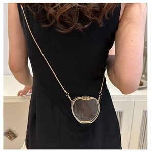 Detailed view of creative apple-shaped transparent acrylic crossbody bag with gold chain