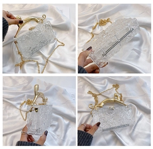 Detail view of acrylic clutch featuring gold leopard handle and ice crack texture pattern