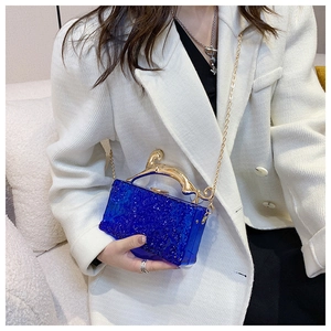 Blue acrylic clutch featuring a detailed gold leopard handle and sleek chain strap