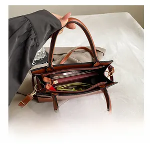 Interior view of large capacity tote bag showing phone, wallet and sunglasses storage