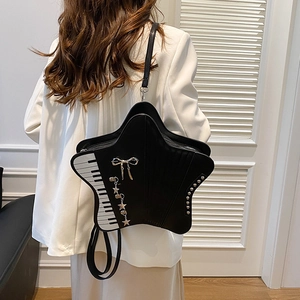 Star-shaped black crossbody bag with piano key design and metallic star charms