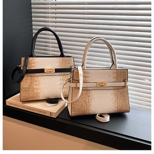Close-up of black and white stone-patterned tote bags with golden metal twist locks