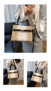 Detail of tricolor crocodile pattern tote bag with gold lock and black handle