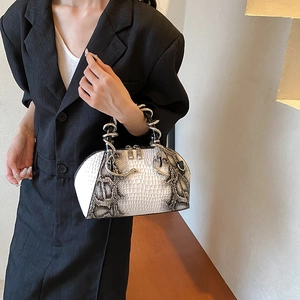 Chic shell handbag with stone texture and snake-shaped metal handle shown on model