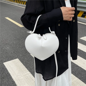 Minimalist white heart-shaped PU leather handbag with adjustable crossbody strap