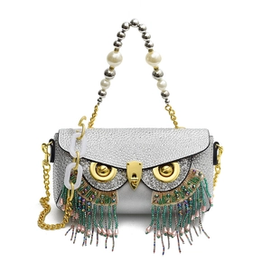 Sparkly owl-shaped crossbody bag with rhinestone finish and colorful beaded tassels