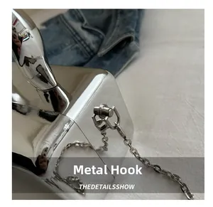 Detailed close-up of the silver mirror acrylic bag with durable metal hook and chain strap