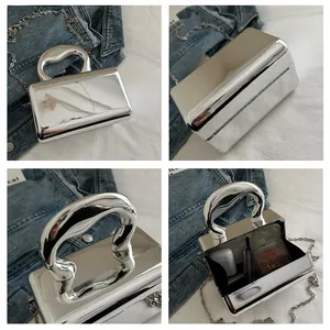 Silver mirror acrylic hard shell clutch bag showing interior capacity and chain strap