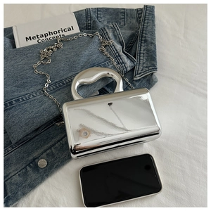 Silver mirror acrylic evening bag with heart handle and chain strap for size comparison