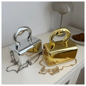 Detail of mirror-finish acrylic box bags with oversized round handles and metal chains