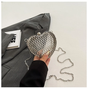 Detail of silver heart-shaped metal mesh handbag with chain and sphere clasp