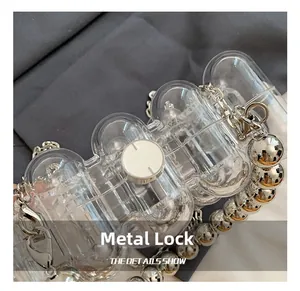 Detailed view of silver metal clasp and wave textured acrylic on luxury crossbody clutch