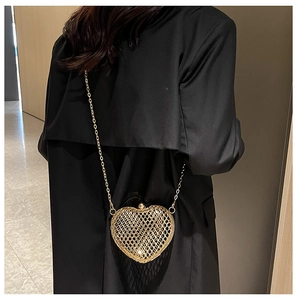 Detail of gold heart-shaped hollow metal mesh mini crossbody bag with chain strap