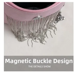 Detailed macro view of the silver magnetic snap closure on a pink studded leather bag