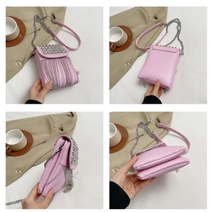 Pink crossbody bag with silver rivets and metallic tassels shown in multiple view angles