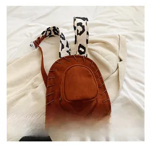 Detailed close-up of suede cowboy hat backpack featuring unique animal print straps