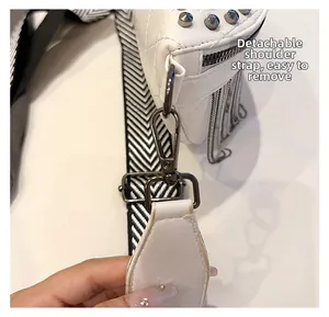 Detail of detachable woven strap and silver hardware on white studded fringe bag