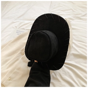 Detail of a black wide-brimmed felt hat with decorative stitching in retro western style