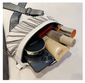 Detail showing white leather chest bag interior with silver fringe and ample storage space