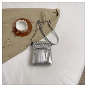 Detail of silver crossbody bag with sparkling rhinestones and delicate metal fringe tassels