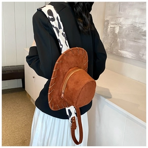 Detail of creative cowboy hat backpack in brown suede with cow print straps