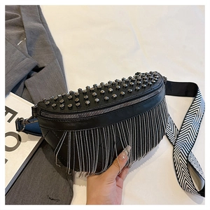 Detail of black leather waist bag with silver cone studs and metal chain fringe