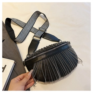 Detail of black leather fanny pack with silver chain tassels and woven guitar strap
