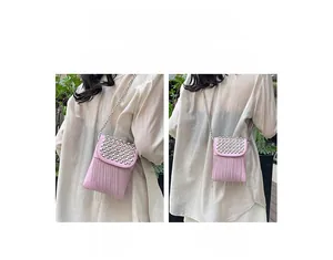 Pink studded mini bag shown in crossbody and shoulder wear styles with chain fringes