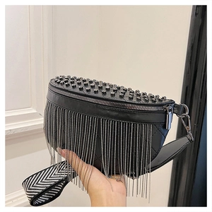 Detail of black quilted leather waist bag with silver studs and long fringe chain tassels