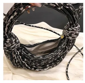 Close-up of leopard print woven handbag interior with light gray lining and smooth zipper