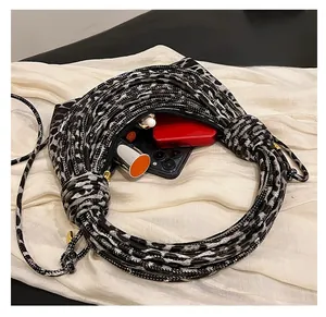 Detailed view of leopard print woven bag interior showing storage space for cosmetics