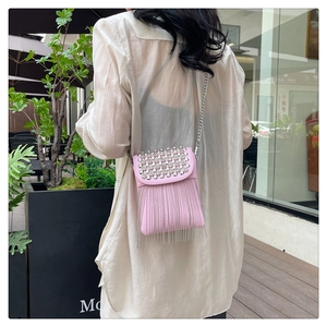Pink crossbody phone bag with sparkling rhinestones and long metallic tassels on the bottom
