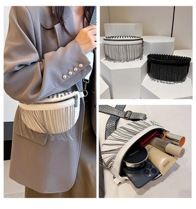 Detailed view of studded crossbody bag interior storage and fringed leather texture