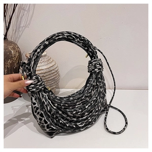 Detail of leopard print woven bag with circular handles and intricate rope texture