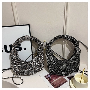 Detailed knit texture of leopard print crescent bags with round handles and strap