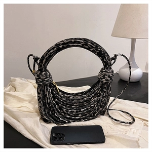 Close-up of leopard print woven handbag with round handle and braided rope texture