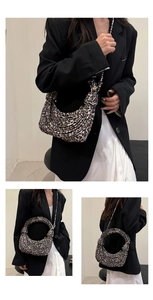 Detail view of leopard print woven hobo bag showing texture and stylish knot shoulder strap