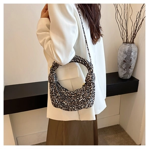 Leopard print woven shoulder bag featuring a unique knot handle and textured canvas finish