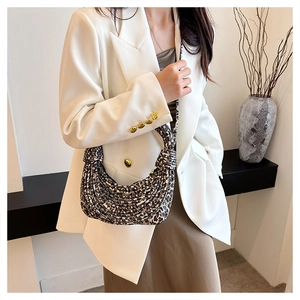 Detail of leopard print woven shoulder bag texture on model in white blazer