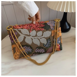 Detail view of retro envelope bag with vibrant floral embroidery and colorful sequins
