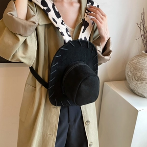 Unique cowboy hat shaped backpack with cow print straps and black suede finish