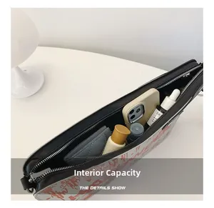 Internal capacity of the black leather mini bag showing phone, wallet and cosmetics
