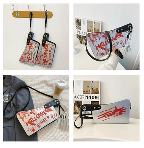 Halloween knife shaped bag with bloody handprint, skull charm and metallic silver finish
