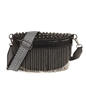 Quilted crescent crossbody bag with silver fringe, studs, and chevron strap