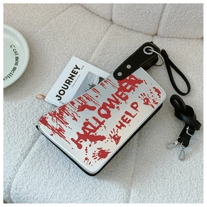 Detail of creative cleaver shape handbag with Halloween blood prints and shoulder strap